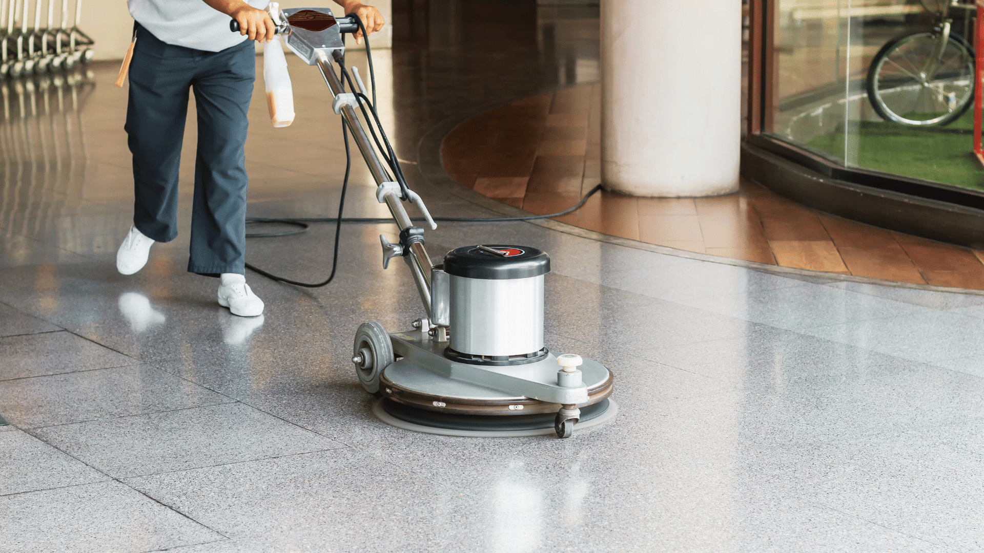 man is cleaning hotel lobby with industrial vacuum cleaner